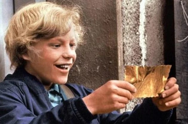 Charlie holds his golden ticket for a Wonka factory tour.